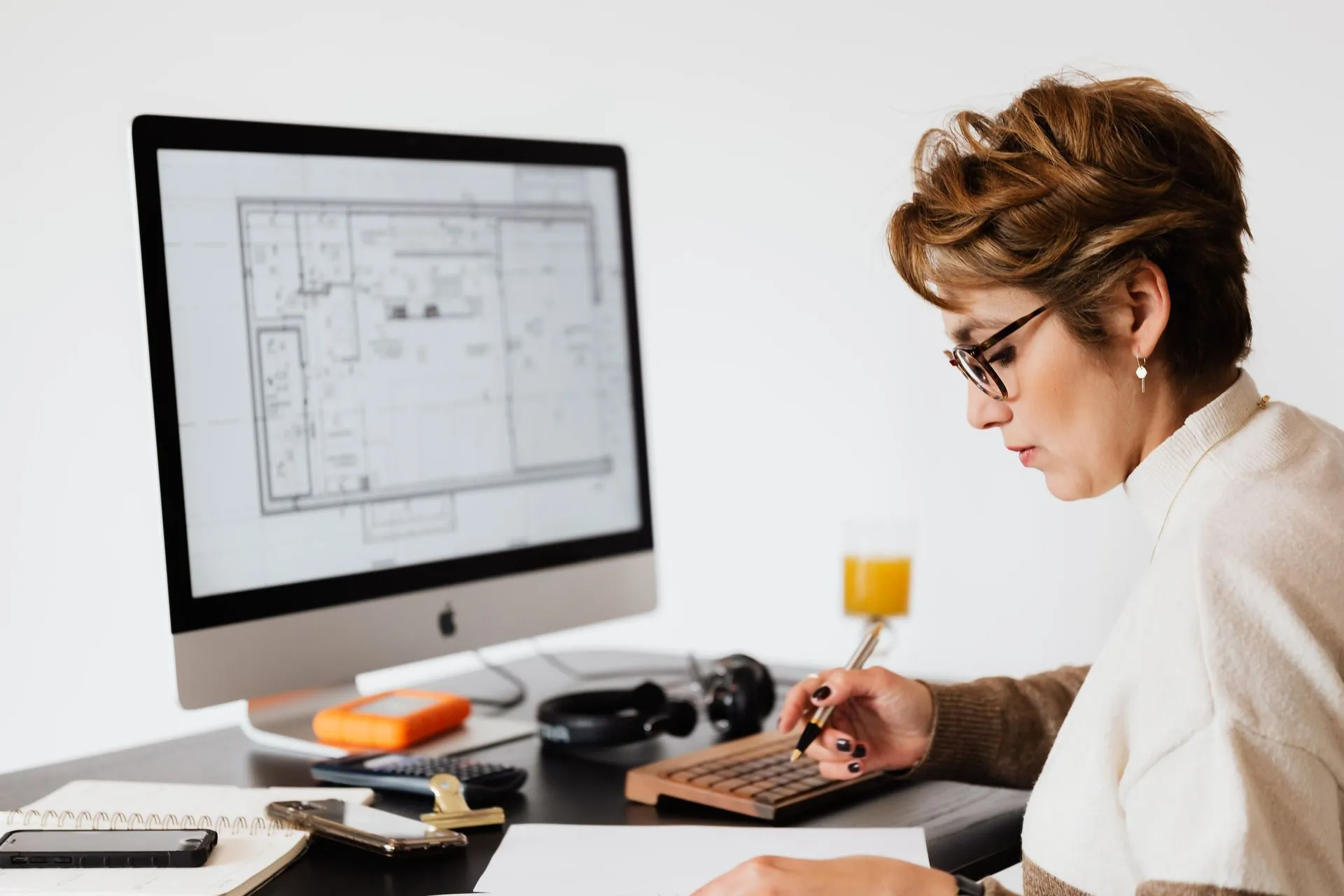 A mortgage operations professional reviewing documents at her desk