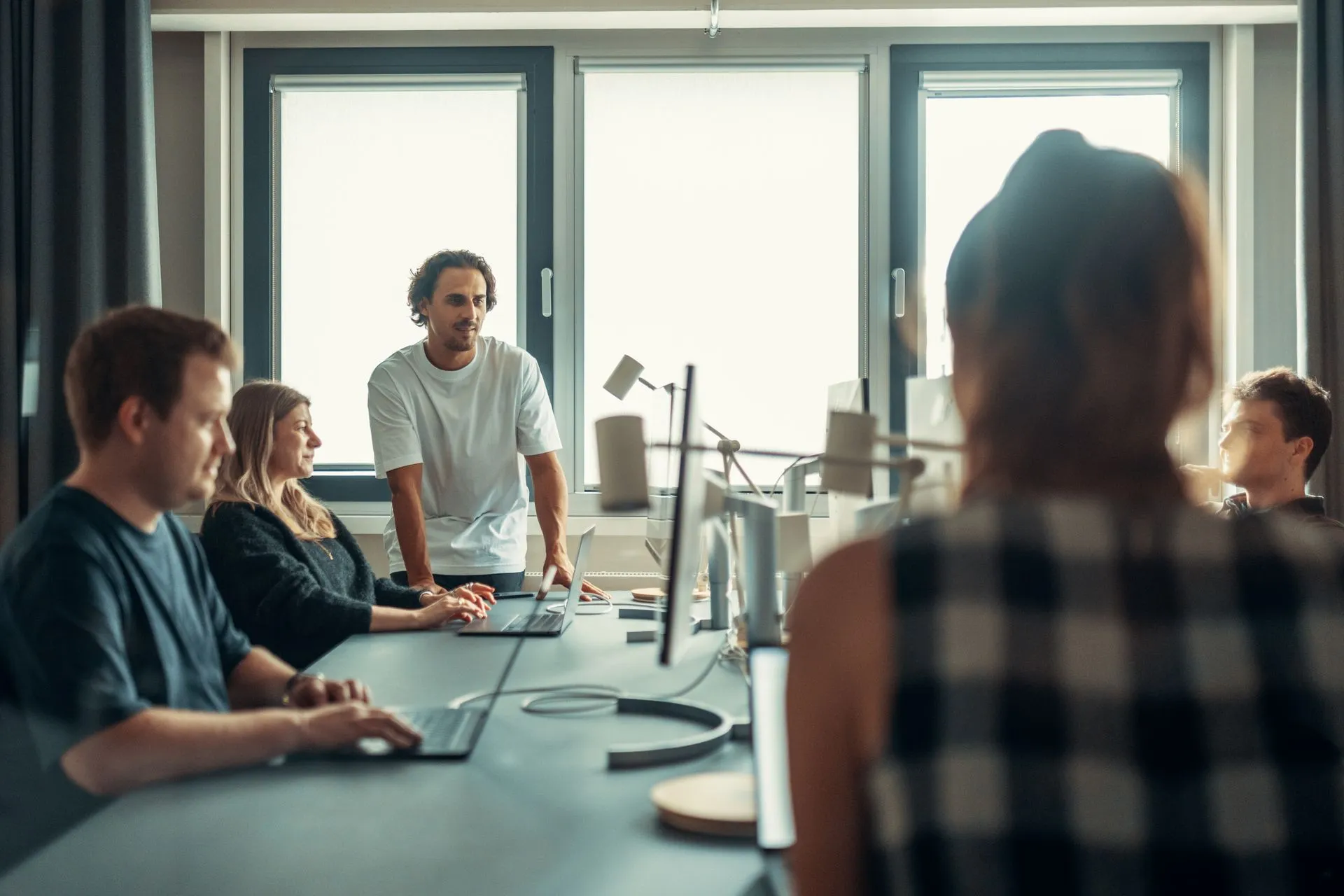 A small team meeting around a table in a modern office
